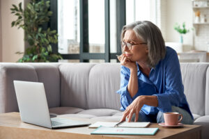 Picture of an older woman doing research online.