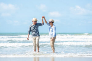 Picture of an older couple walking on the beach.