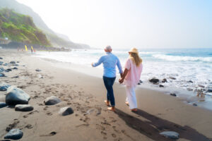 Picture of an older couple walking on the beach.