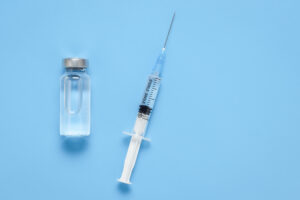 Picture of a syringe and a vial filled with liquid.