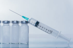 Picture of a syringe and four vials.