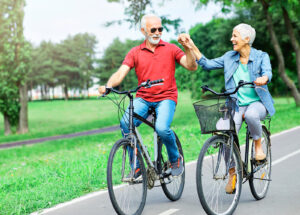 Happy senior couple on bicycles outdoors